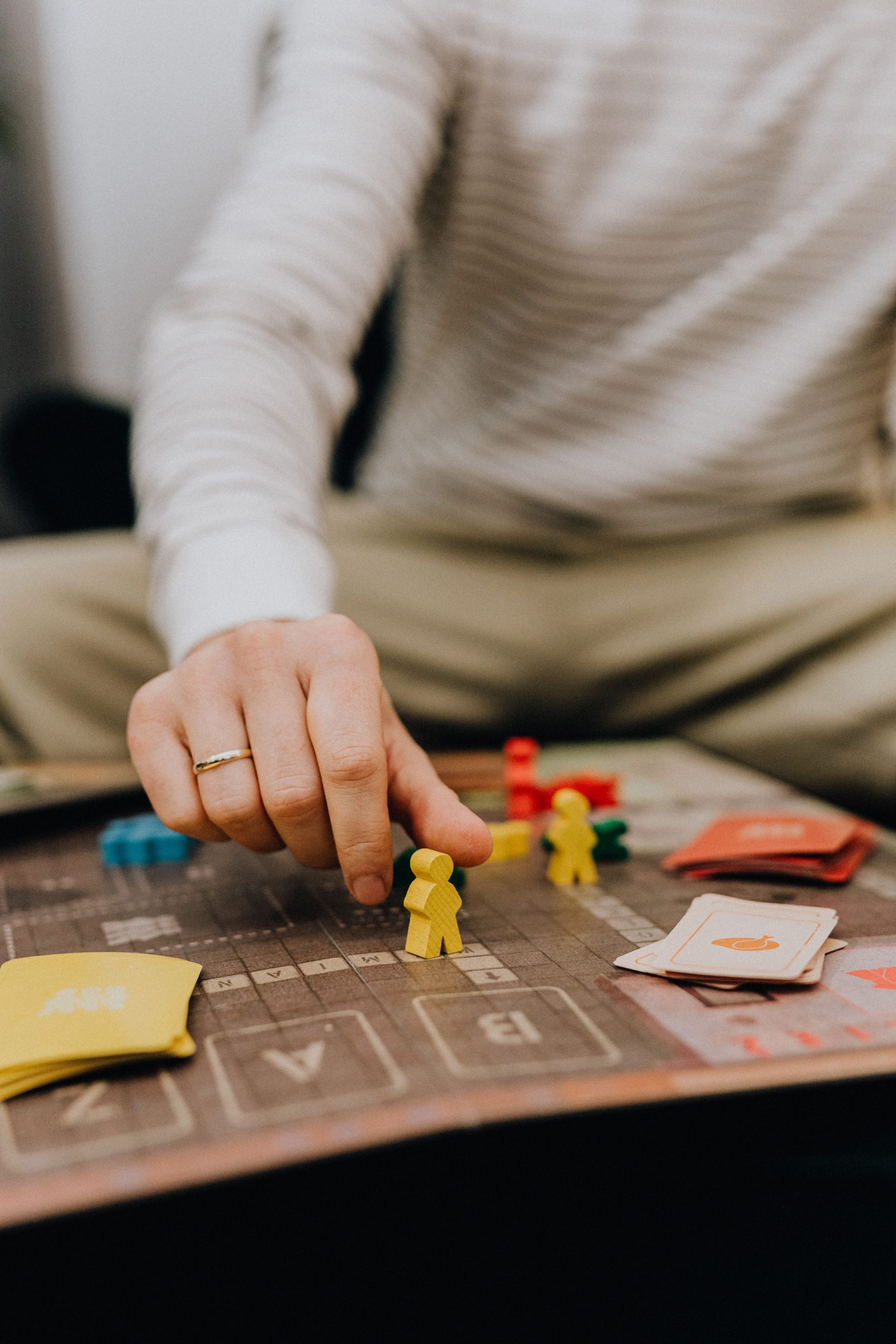 Close-up of a hand placing a game piece on a board, adding strategy to the session.